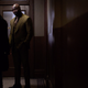 Mike Colter as Luke Cage saying hello to Krysten Ritter as Jessica Jones.